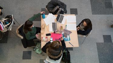 A group of four students studying at a table. 
