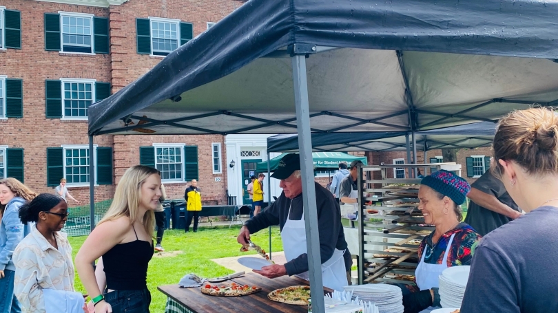 Students getting served pizza 