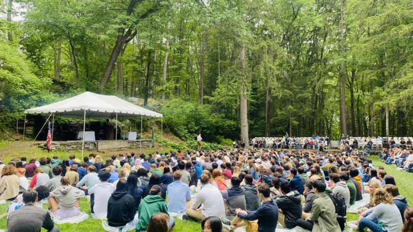 Numerous students sitting in The Bema looking onto a tented stage with guests seated around them