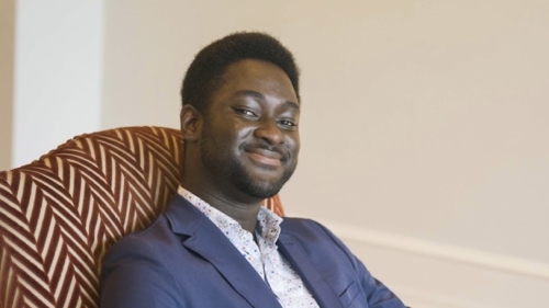 Kwabena Asare '25 sitting in armchair at conference