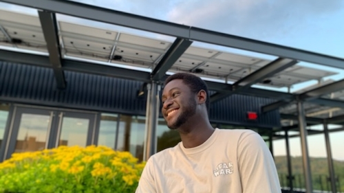 Kwabena Asare '25 Smiling Outside Building