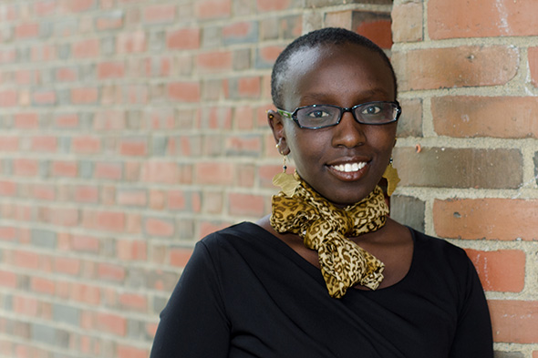 Miriam Kilimo against a brick background
