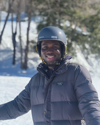 A smiling individual in the center of the picture.