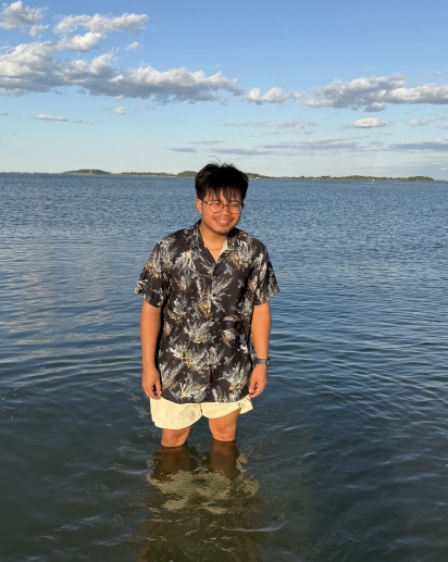 A smiling individual in the center of the picture.