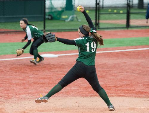 A softball pitcher pitches the ball.