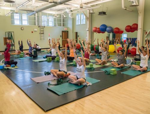 Students attend a yoga class.