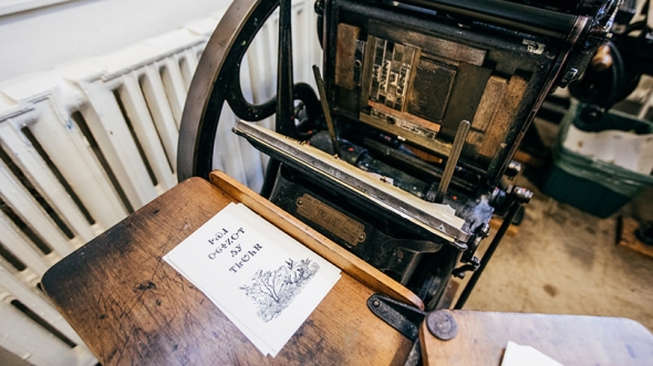 A vintage press in the Book Arts Workshop is used to create prints in the Cherokee language.