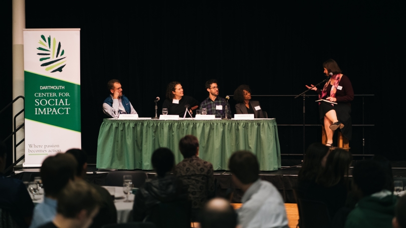 A panel of speakers on stage