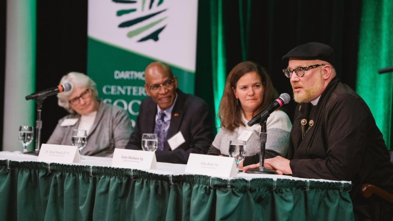 Four panelists sitting on a stage being interviewed at the breaking the mold conference
