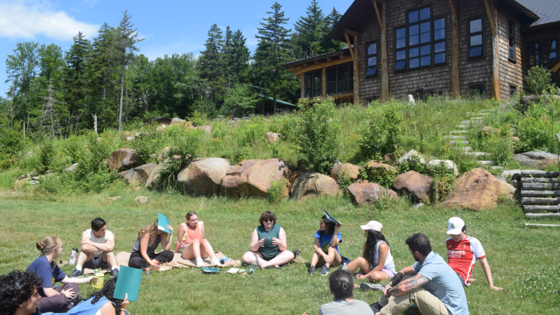 Students sitting in a group circle talking