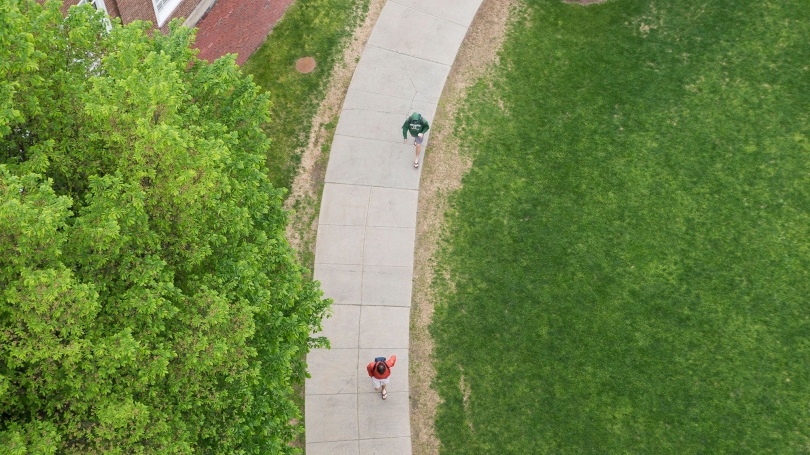 Aerial view of students walking a path near Baker library.