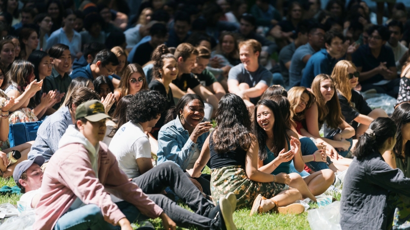 Students seated on sunny lawn