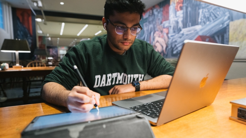Student taking notes on tablet