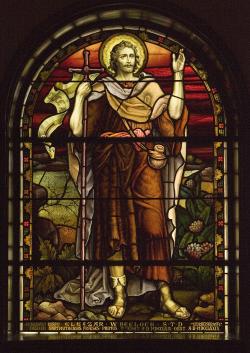 A stained glass window depicting John the Baptist.