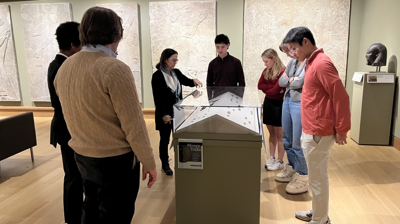 Professor Robert Stewart guides Hanlon Scholars through the Roman Coins exhibit at the Hood Museum