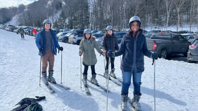A Group of four Dartmouth Students stand on skis. 