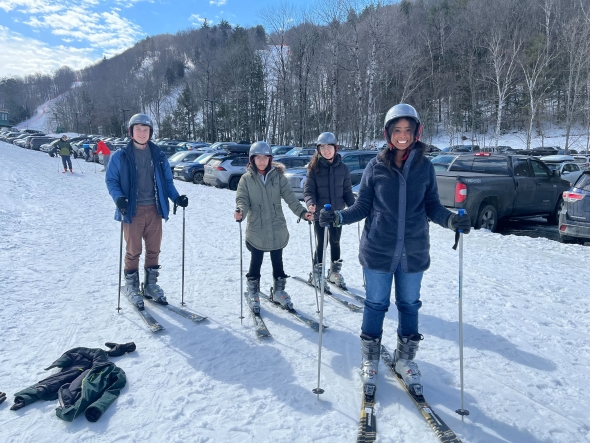 Four Dartmouth Scholars standing on skis