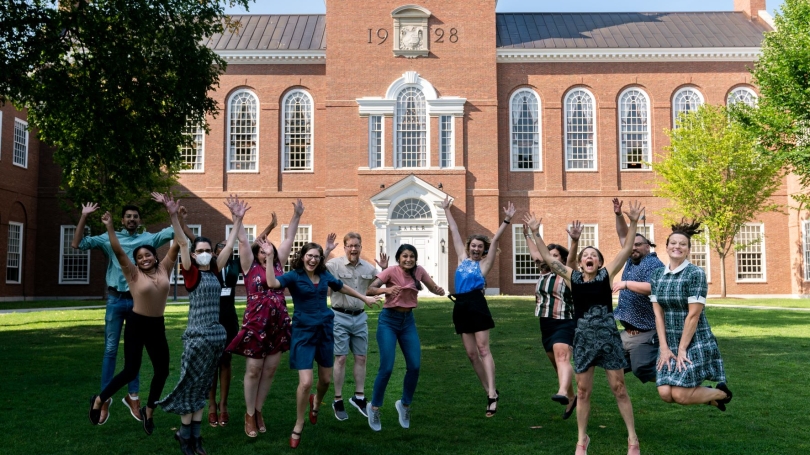 SWC staff jumping in front of library