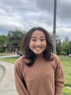 person smiling at camera in natural setting