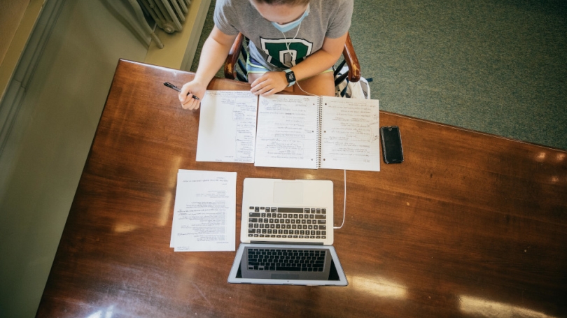 Photo from above a student studying in the East Reading Room.